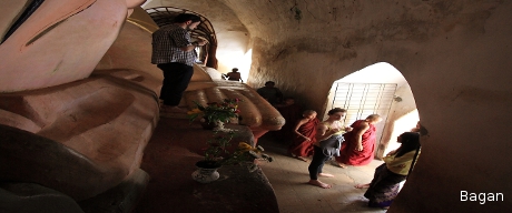 Tourists and young monks inside Bagan Temple.