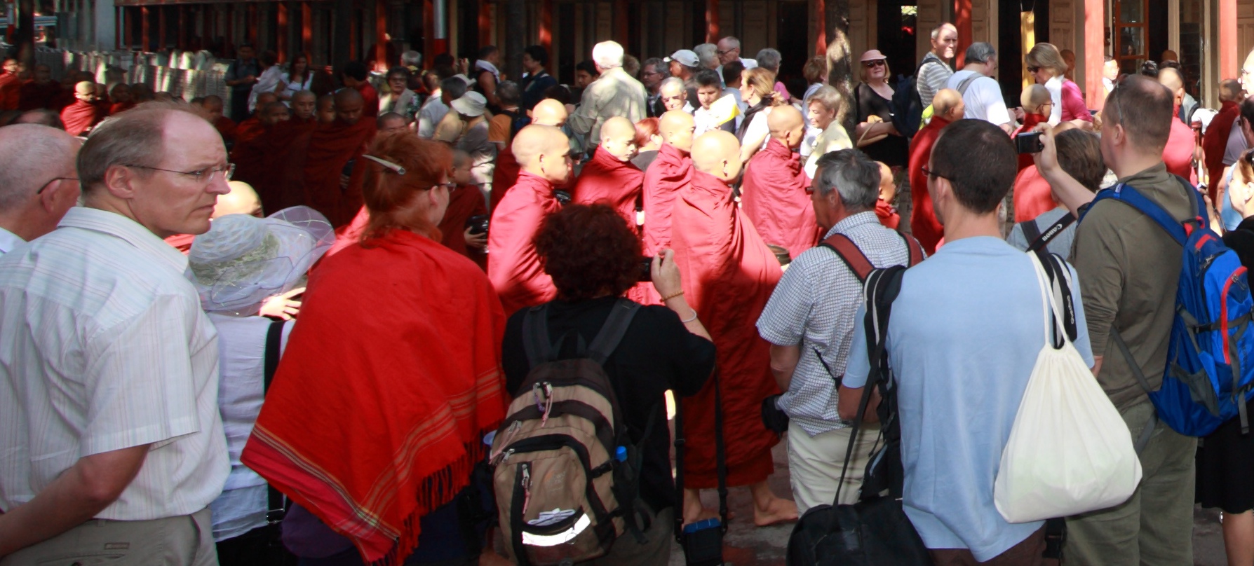 Monks surrounded by tourists in Mandalay